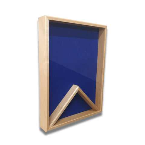 Maple 18x24 vertical shadow box shown at a slight left angle with a blue felt backing and no flag displayed