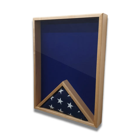 Maple 18x24 vertical shadow box shown at a slight right angle with blue felt interior and a folded American flag in the flag section
