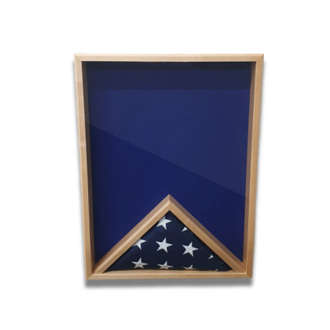 Front view of a maple 18x24 vertical shadow box with blue felt background and a folded American flag displayed inside