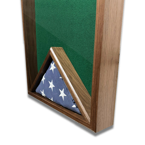 Close-up view of the flag section in a walnut 18x24 vertical shadow box showing a folded American flag against green felt